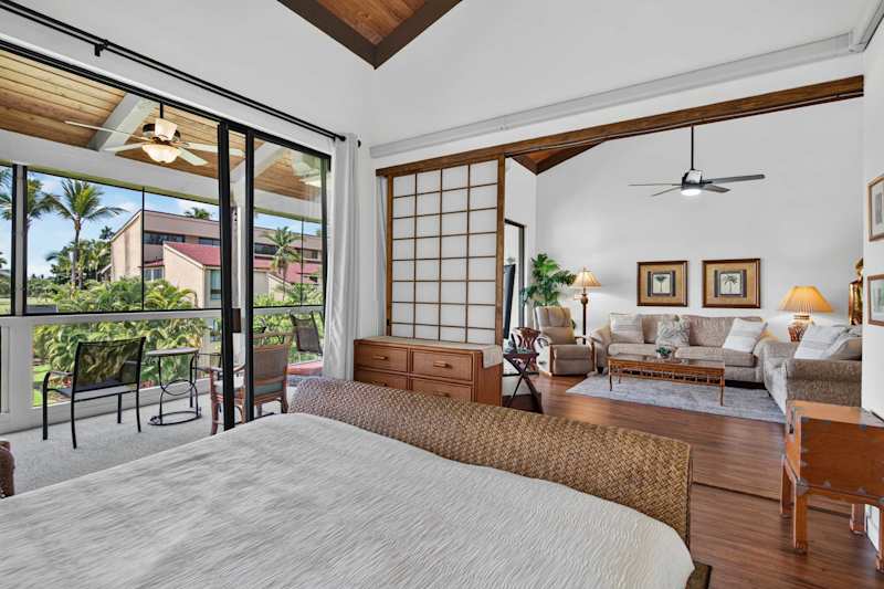 Bedroom with king bed opening to direct lanai access and living area