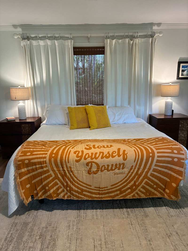 Cozy primary bedroom setup with bedside tables, lamps, and soft drapes