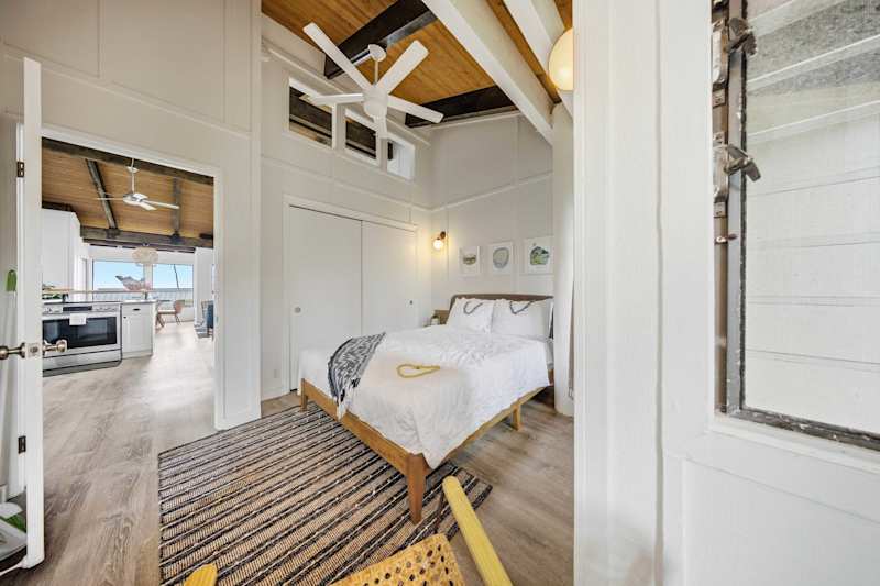 Third bedroom with ceiling fan and bright windows