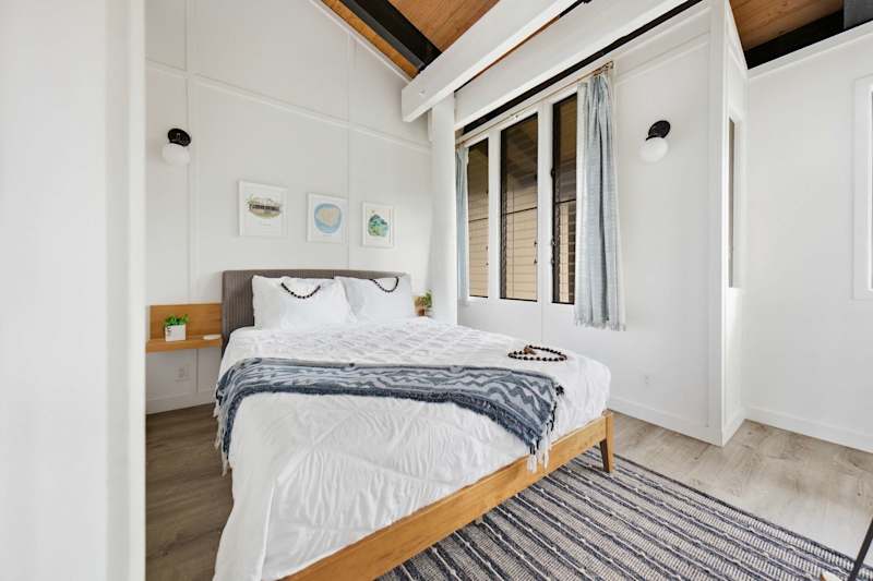 Third bedroom with queen bed and bright windows