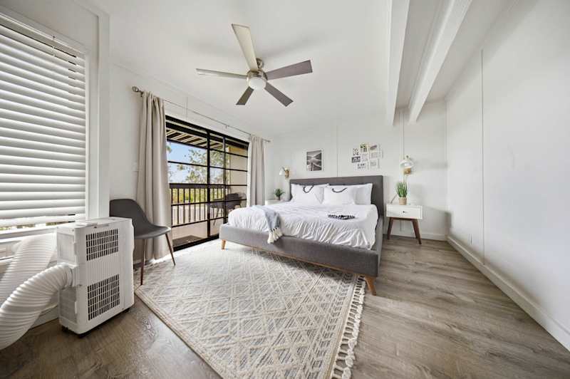 Primary bedroom with ceiling fan, AC and lanai access