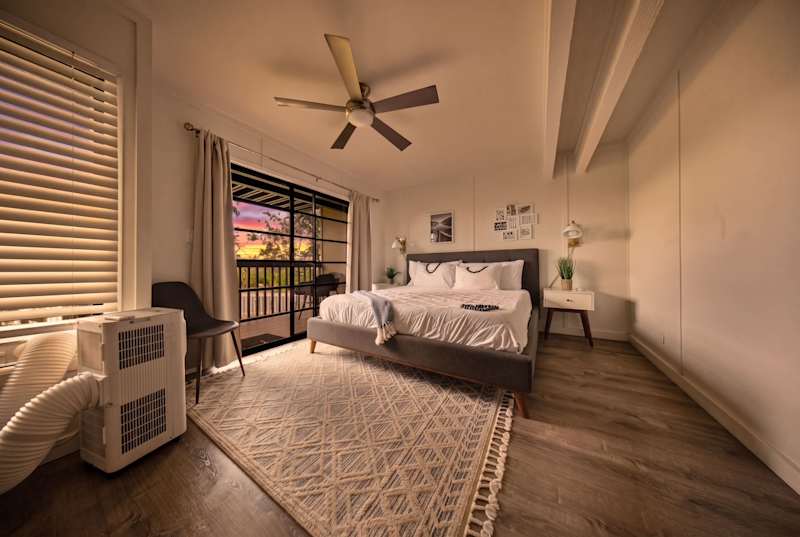 Primary bedroom with sliding glass doors to the lanai and air conditioning