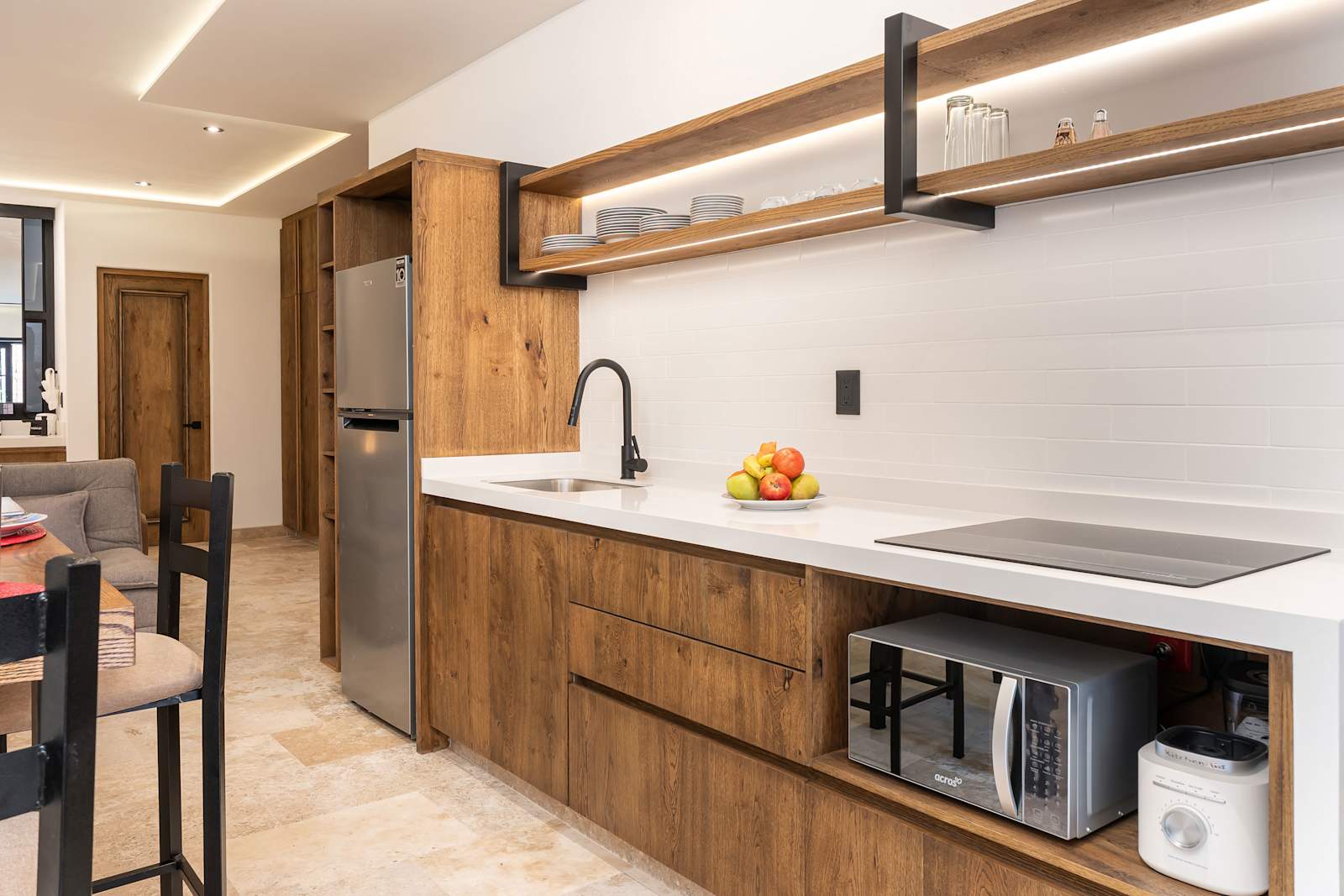 Fully equipped kitchen with wood cabinetry and appliances