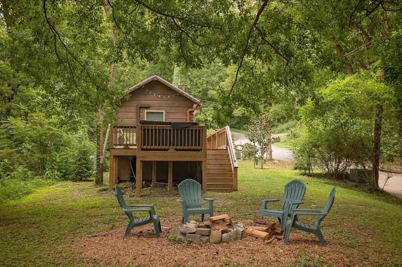 Private fire pit and seating off of back deck with private hot tub.