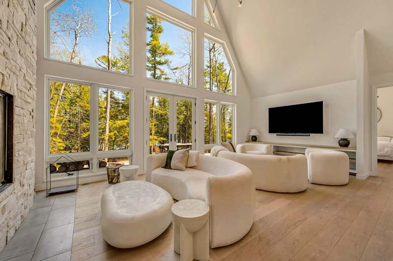 Great room with floor-to-ceiling windows at a DoCo home in Jacksonport