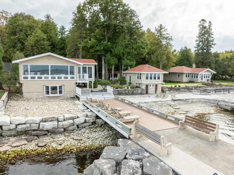 Discover the ultimate group getaway at Three Leaves Bayside Retreat in Egg Harbor, Wisconsin. Perfect for large families and reunions, this unique property features four charming cabins, a communal kitchen and mess hall, sauna and stunning waterfront