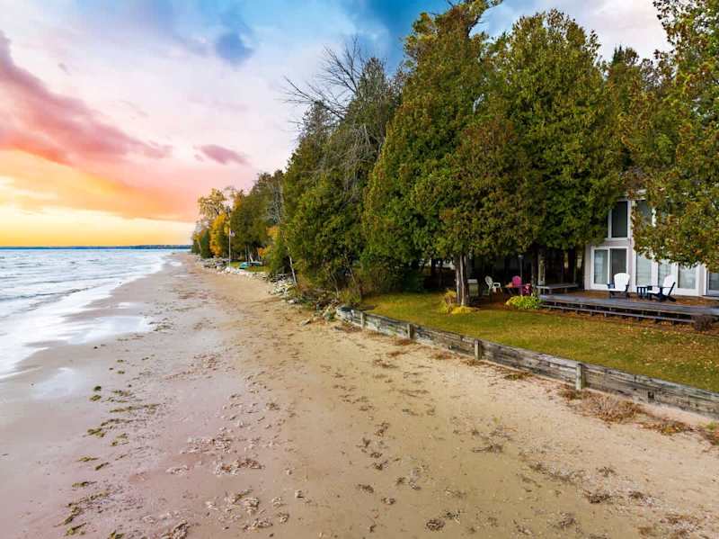 One of the standout features of this property is the sandy beach right out your back door. Build sandcastles with the kids, stroll along the shore, or kayak over to Cave Point County Park.