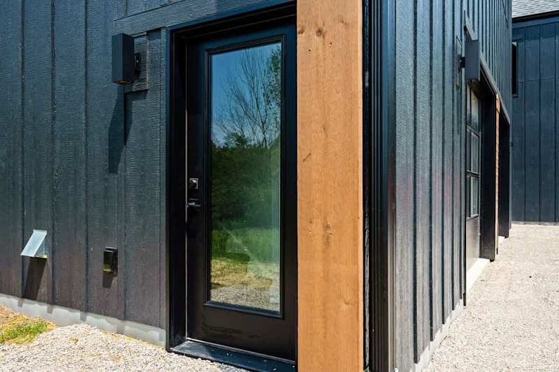 To enter the loft, you will use the side door of the garage and walk up the stairs.