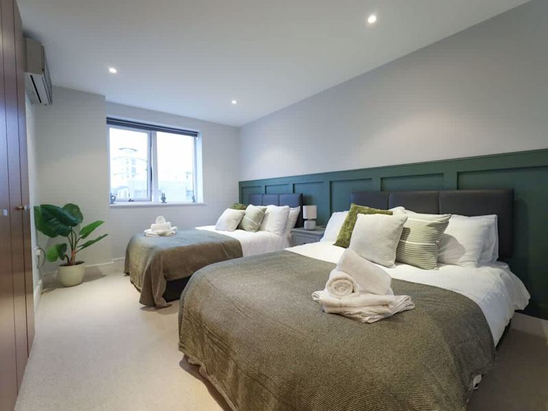 A bedroom made up with towels and linen in our penthouse