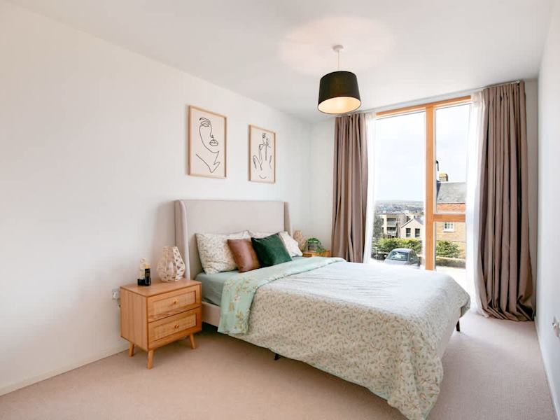 A made-up king-size bedroom in one of our homes in Chatham