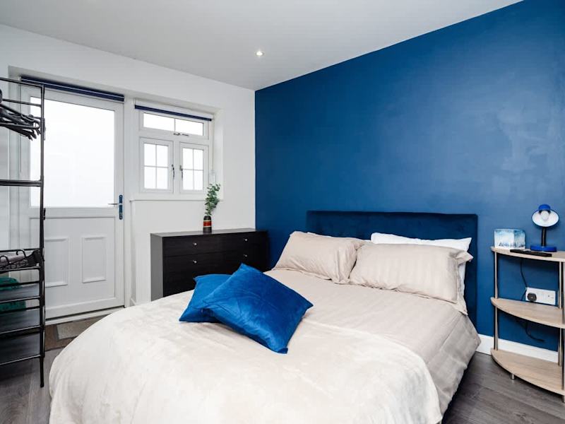 A bed made up with fresh linen in our Maidstone annexe