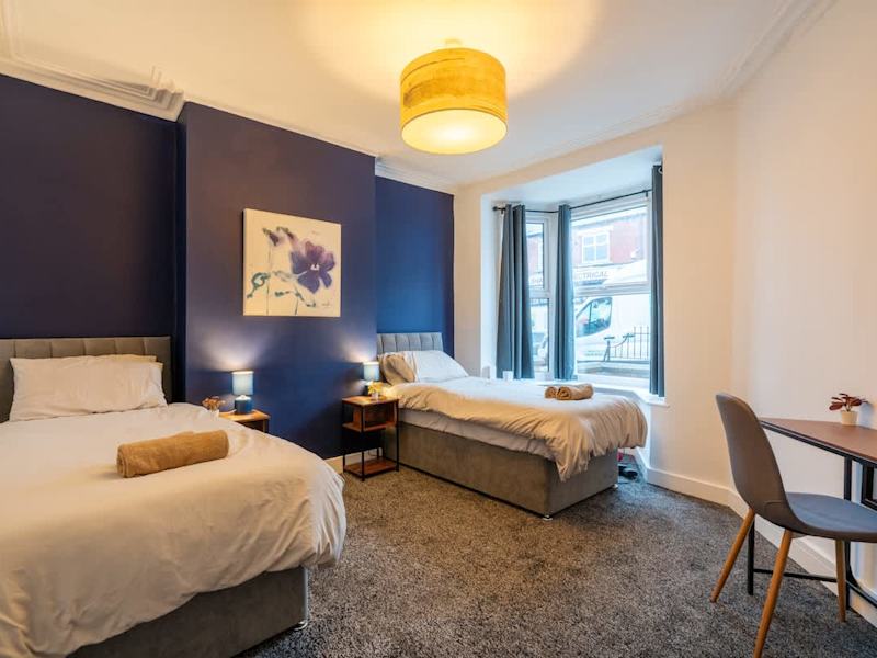 A bedroom made up with fresh linen and towels