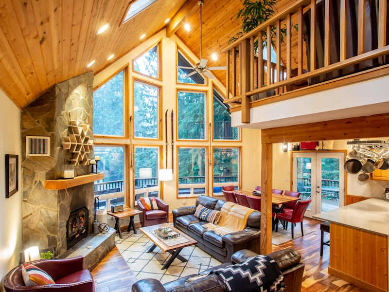 Relax in the living room with vaulted ceilings and wood burning fireplace. Our place has great views of the trees and has the perfect open layout for togetherness. 