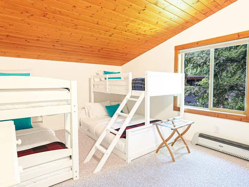 Cozy bunk room with three twins and one full bed. 