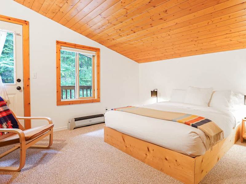 Secondary bedroom with plush queen bed and Apple TV, with balcony access for that first morning sip! 