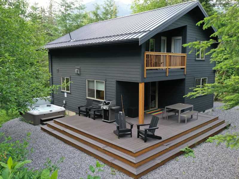 Large patio with BBQ and hit tub, your outdoor oasis awaits! 