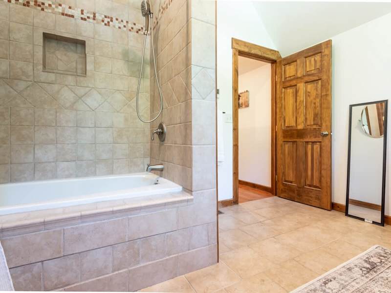 Full bathroom on the second floor with a large soaking tub and huge double vanity, perfect for storing toiletries.