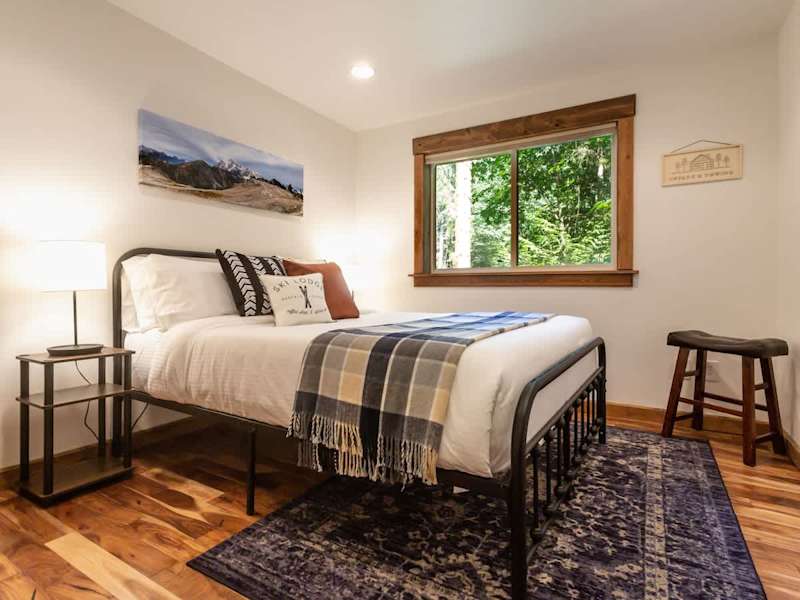 Downstairs bedroom with a cozy queen bed. 