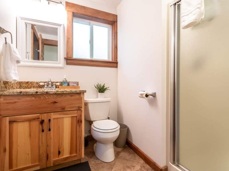 Downstairs bathroom with shower and single vanity. We've installed heated floors for ultimate luxury and comfort:)
