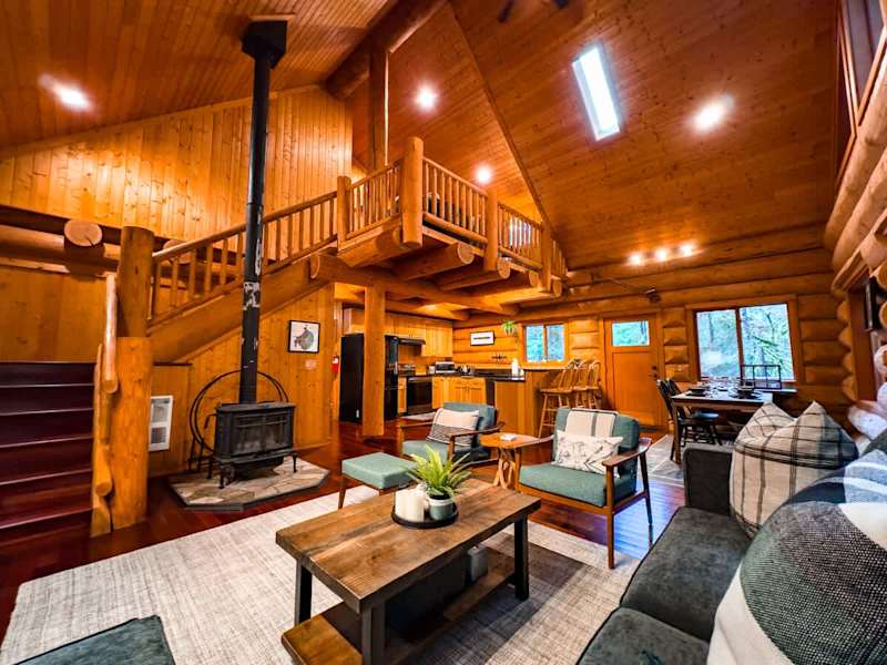Cozy up next to the wood burning fireplace in the open layout of this stunning log home. 