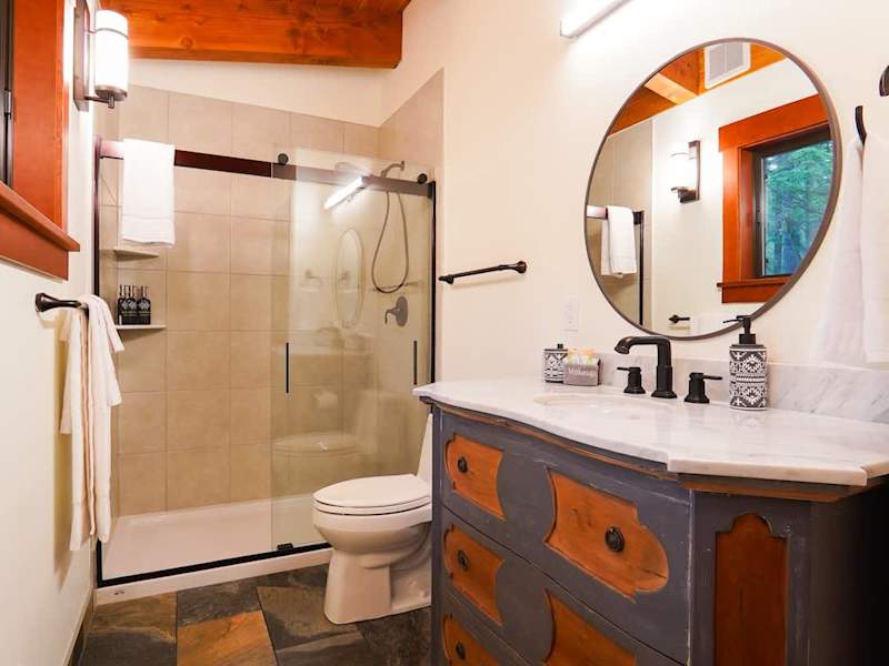 Full bathroom with custom single vanity. Body wash, conditioner, and shampoo all from Public Goods. 