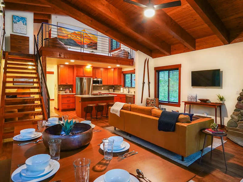 Looking over the dining room table towards the living room and kitchen.