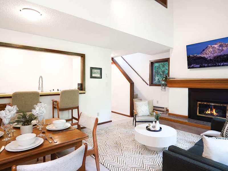 Living room and dining table with kitchen in the background 