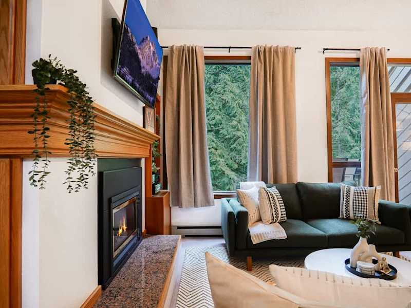 Living room fire placing with view of the forest