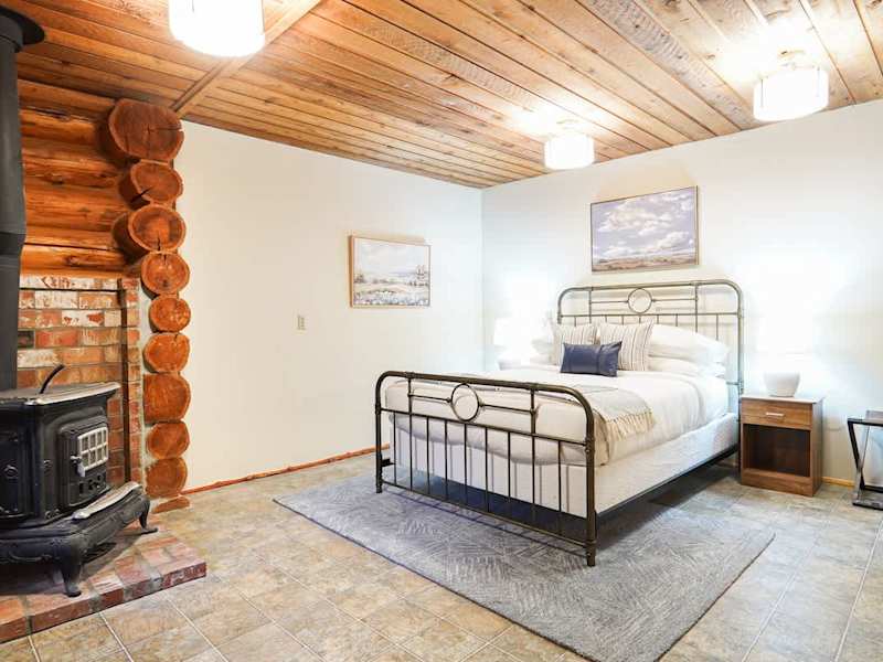 Downstairs secondary bedroom with Helix queen bed and attached half bath.