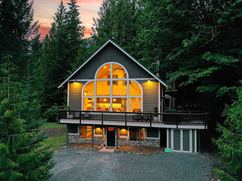 Arched windows and a vaulted roofline surrounded by the trees