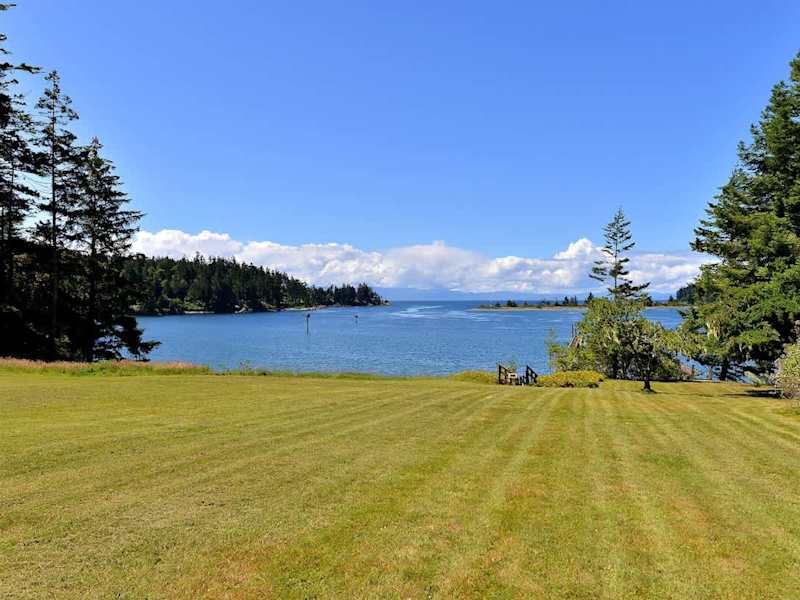 Large lawn which cascades down to the water.
