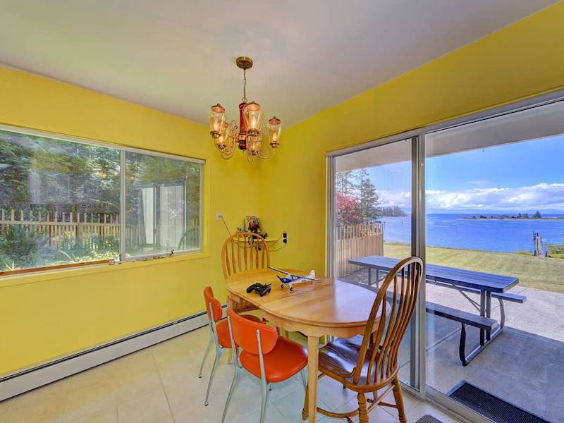 Dining area with patio access and ocean views.