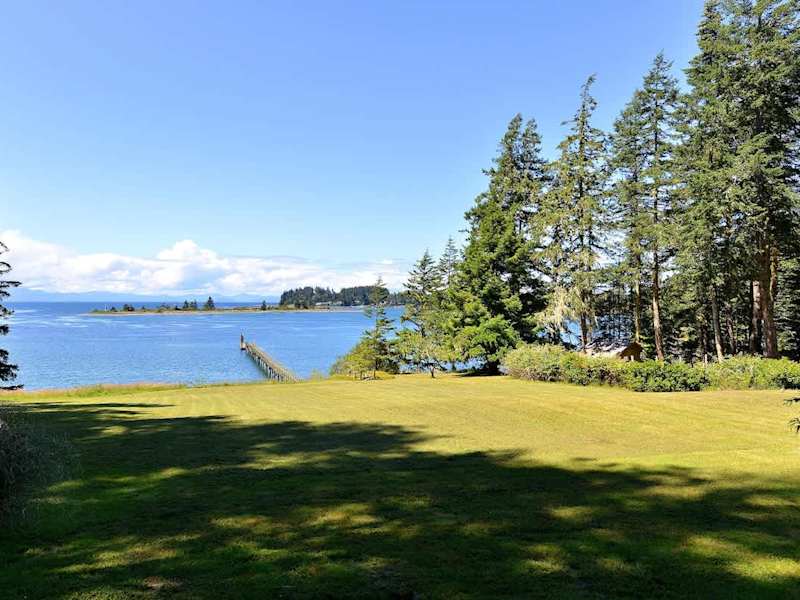 Large lawn which cascades down to the water.