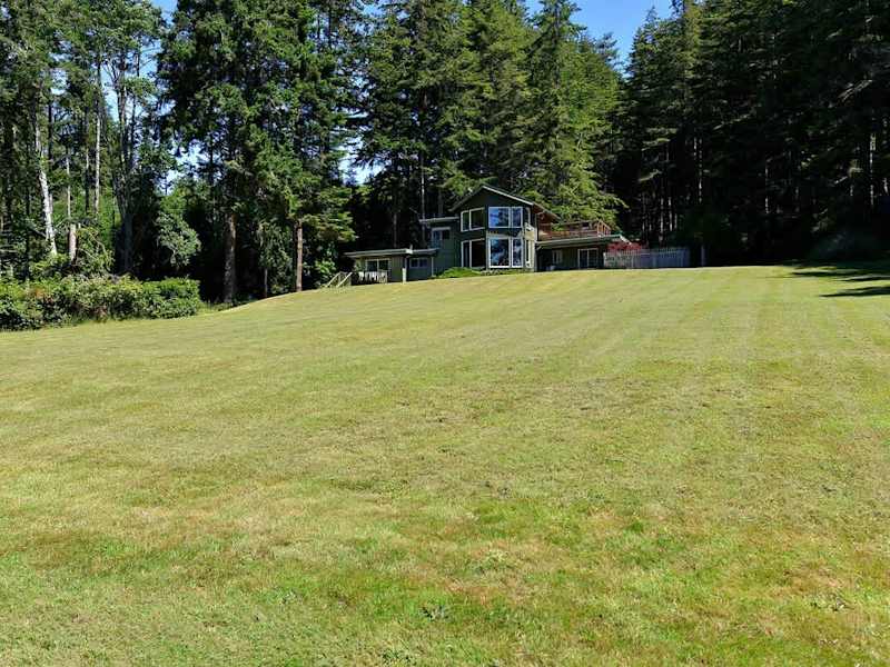 Large lawn which cascades down to the water.