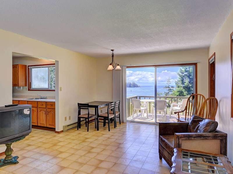 Living room in the attached suite with ocean views and  deck access.