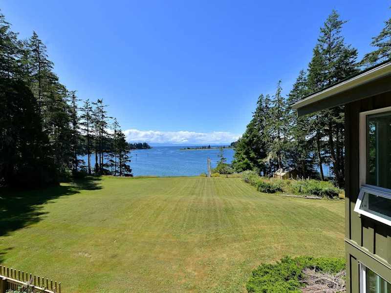 Large lawn which cascades down to the water.