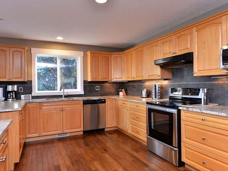 Large and fully equipped kitchen with granite counter tops and stainless steel appliances.