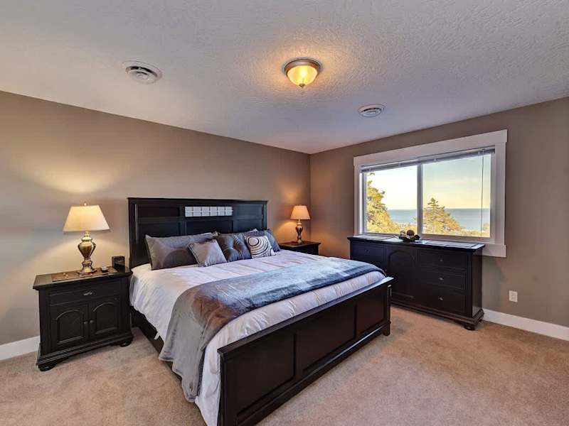 Second master bedroom suite with king size bed, private ensuite and ocean views. 