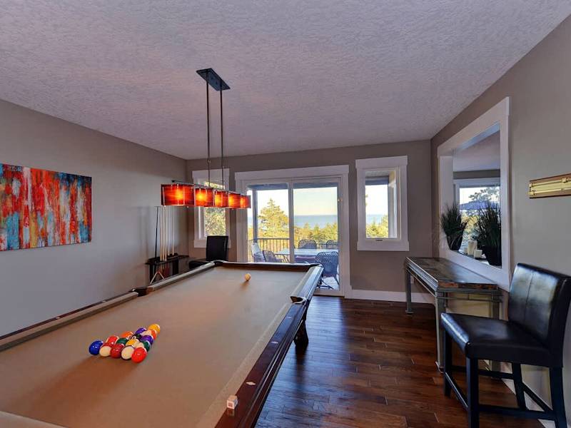 Large billiards room with access to the deck.