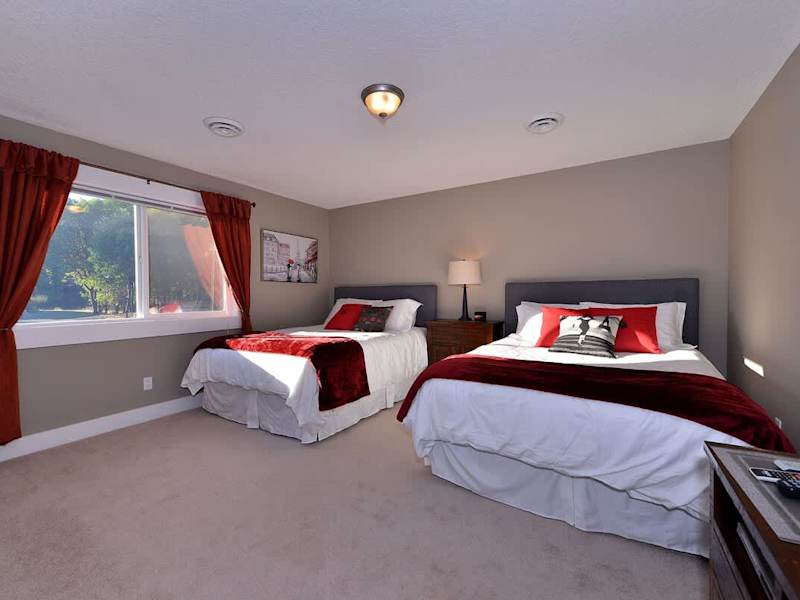 Third bedroom with two queen size beds. This bedroom also shares a four piece ensuite with the fourth bedroom. 