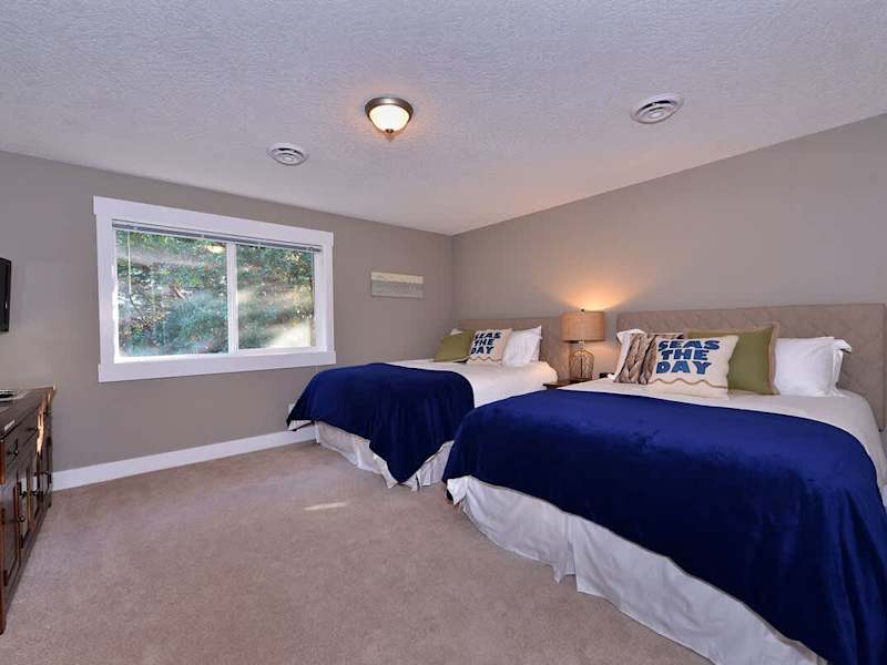 Fourth bedroom with two queen size beds has access to a four piece bathroom which is also shared with the third bedroom.