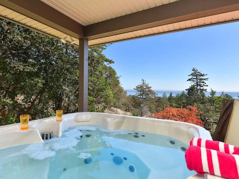 Hot tub overlooks the Juan de Fuca Strait and Olympic Mountains.