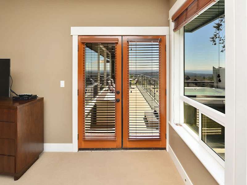 Upper Main level master bedroom with King bed and deck entrance.