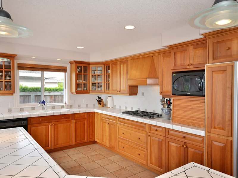 The gourmet kitchen with custom cherry cabinetry