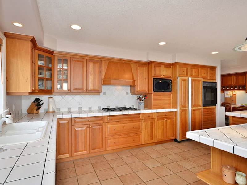 The gourmet kitchen with custom cherry cabinetry