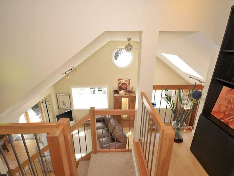 The lofted ceiling of the cottage, lovely wood work accents, and large windows create a bright and open ambiance which is carried throughout the residence.