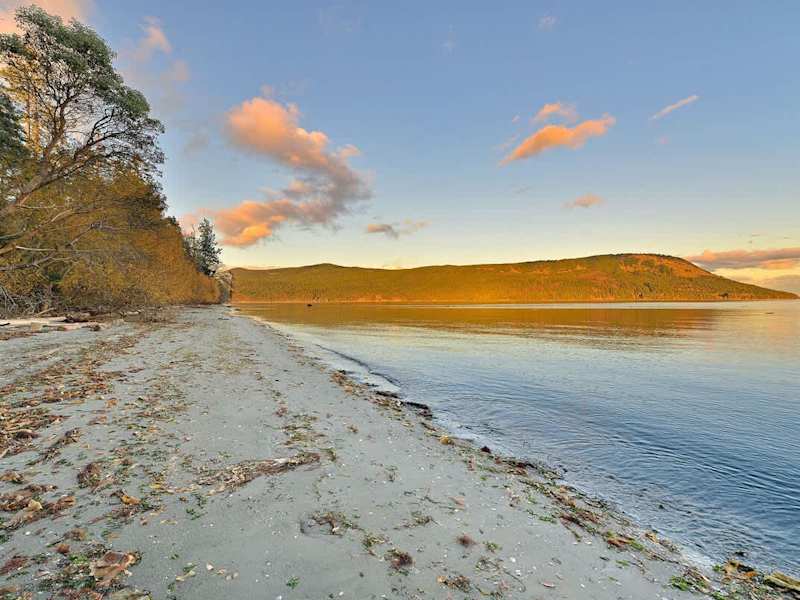 Sandy beach below the house.