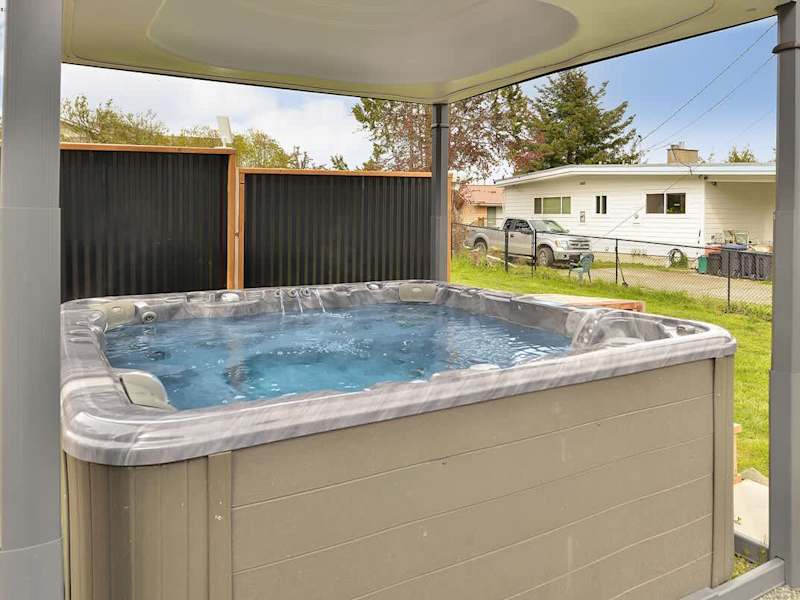 Covered hot tub with automatic top lift.