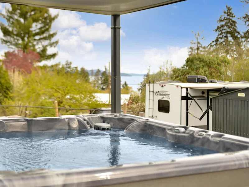 Covered hot tub with automatic top lift.