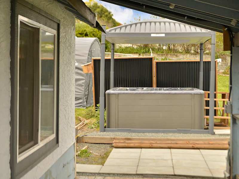 Covered hot tub with automatic top lift.